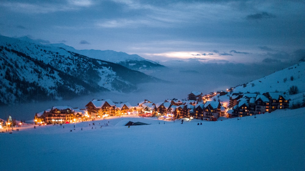 brown wooden houses surrounded by mountain taken at nighttime