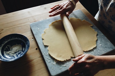 man holding brown rolling pin bake zoom background