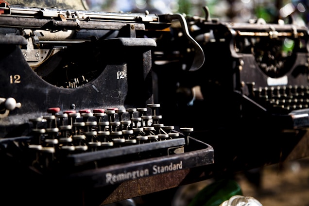 A close-up of hands delicately aligning type on vintage letterpress machinery, showcasing craftsmanship and attention to detail.