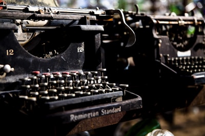 A close-up of a delicate resin model of a vintage typewriter, showcasing fine details and glossy finish.