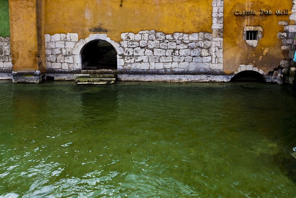 white and orange concrete structure beside body of water