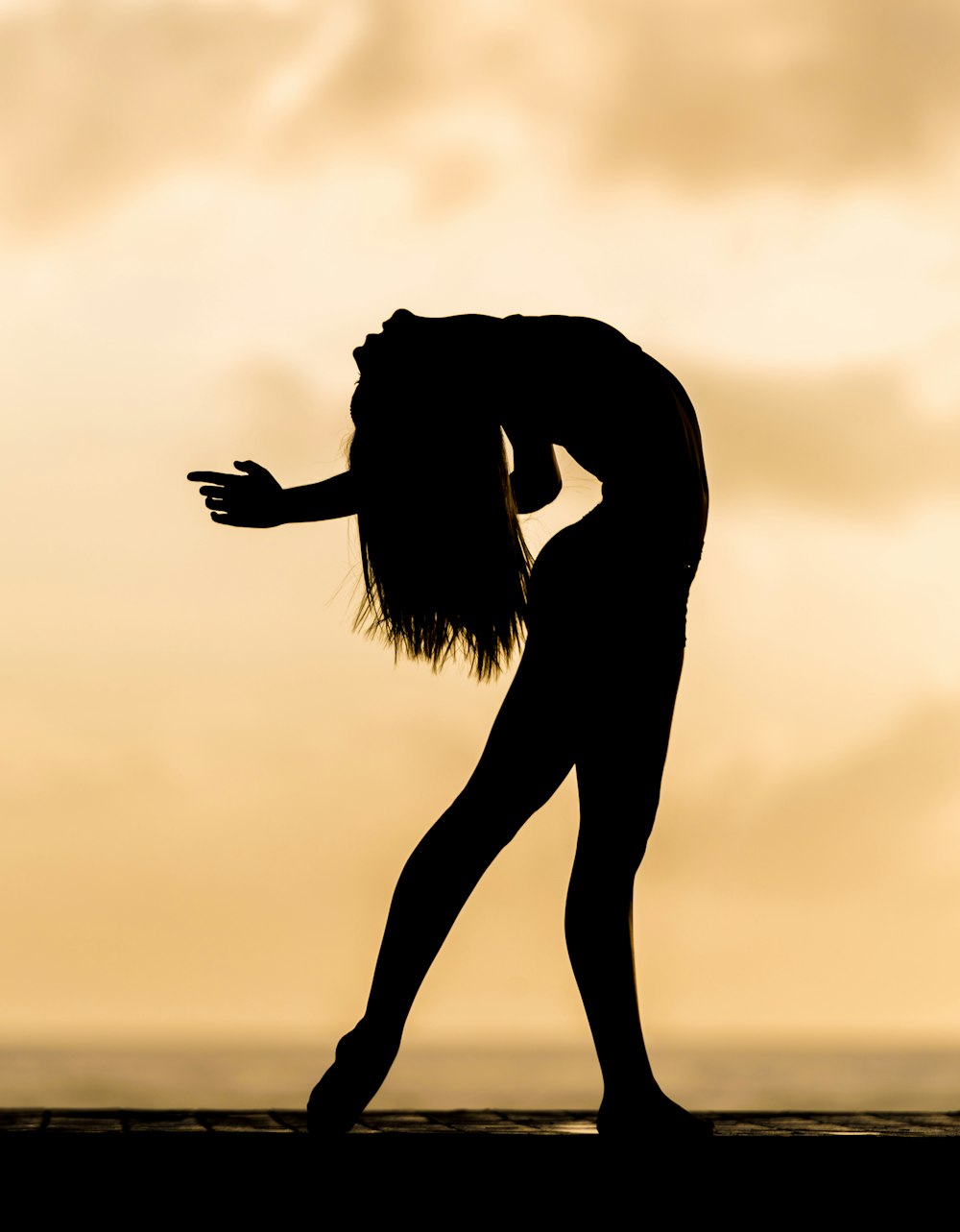 silhouette of bending woman