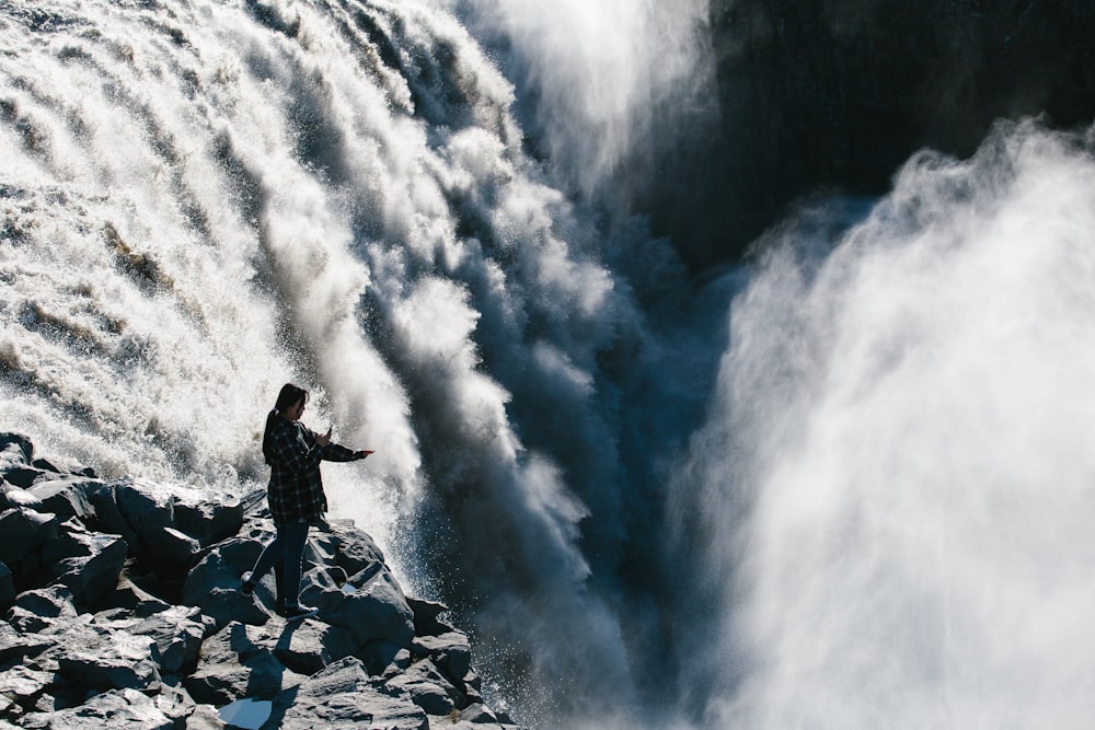 person standing waterfalls