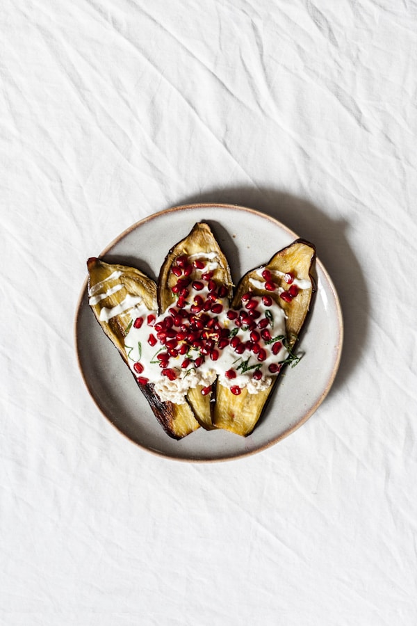 White plate with cream on top of nuts
