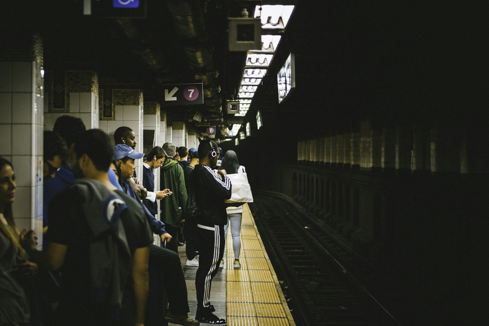 Canon EOS 7D + Canon EF 75-300mm f/4-5.6 USM sample photo. People standing in train photography