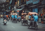 man driving white motor scooter on road
