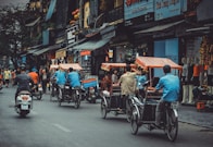 man driving white motor scooter on road