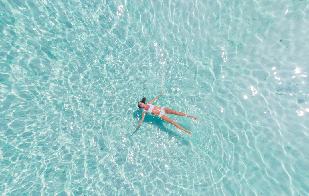 woman swimming on body of water