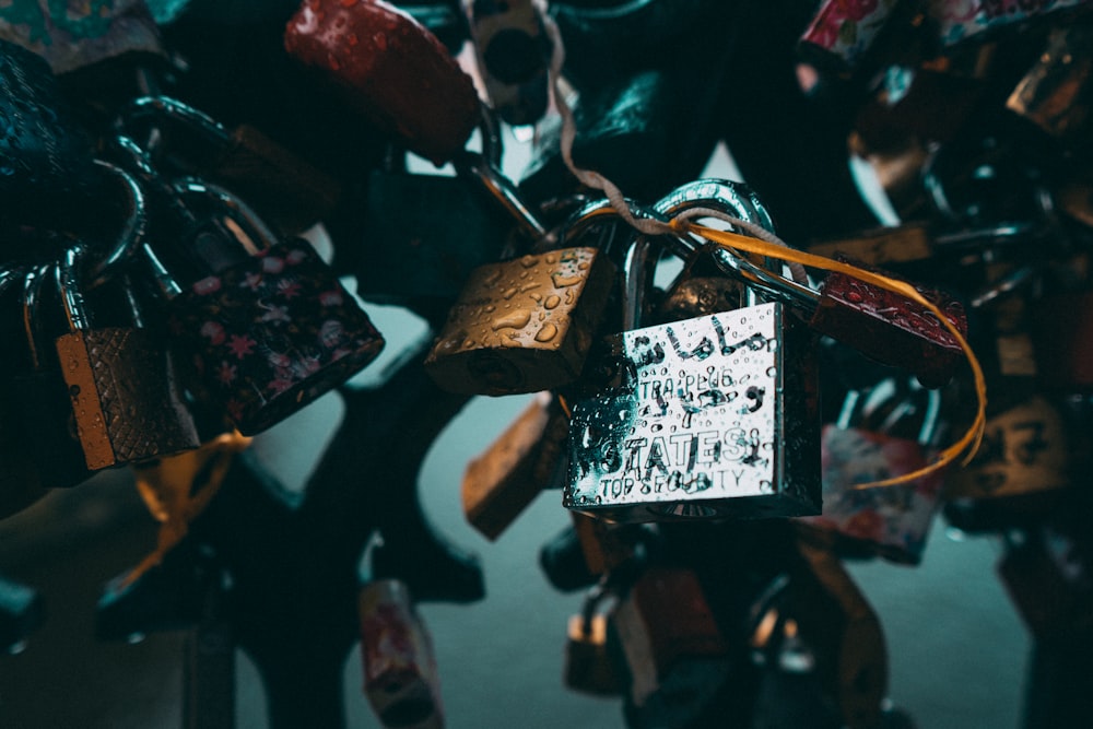 closeup photo of padlocks on metal grill