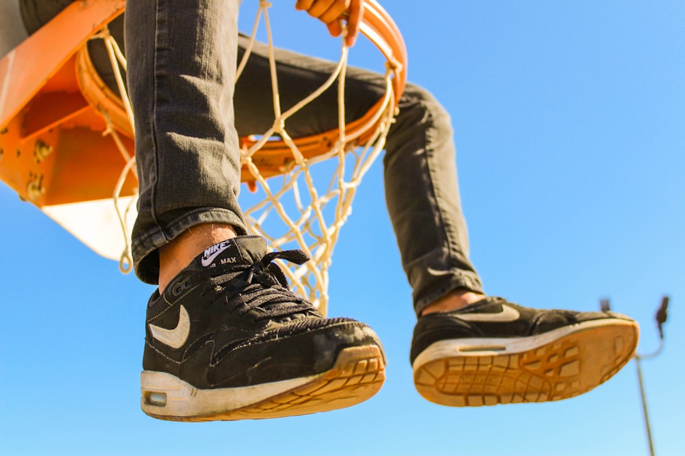 person sitting on basketball ringboard