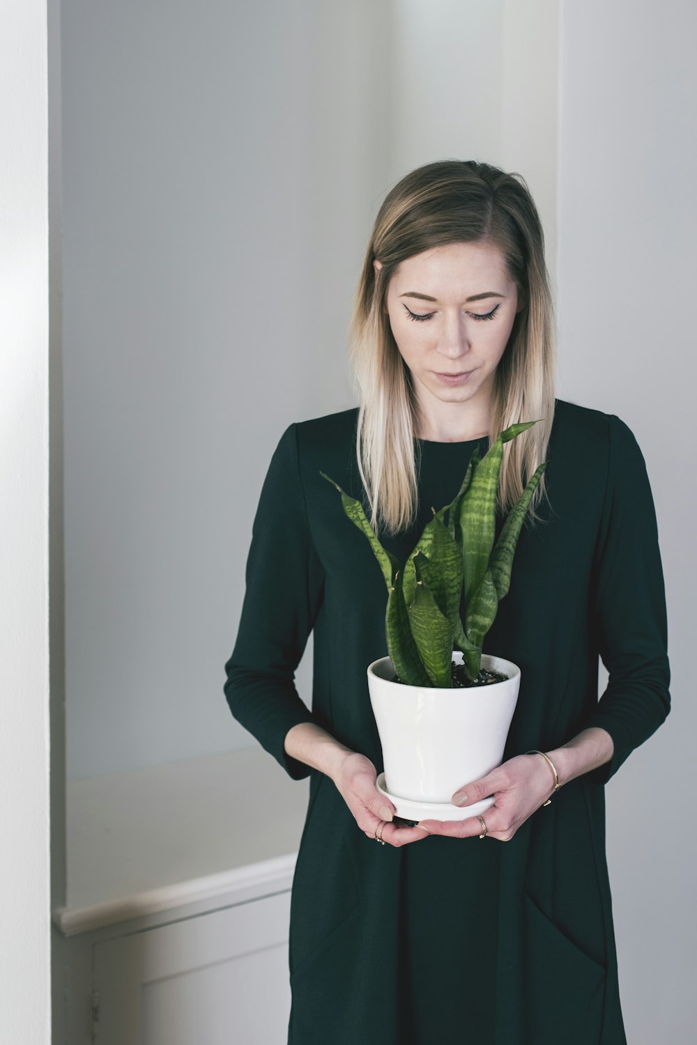 woman holding the potted green viper plant