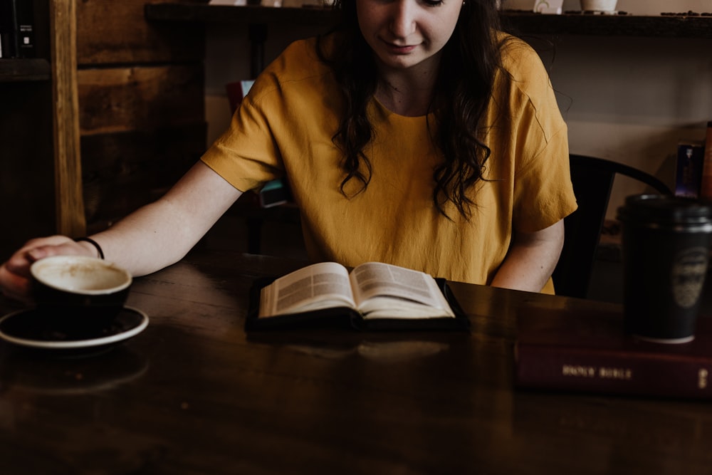 woman sitting on chair in front of book