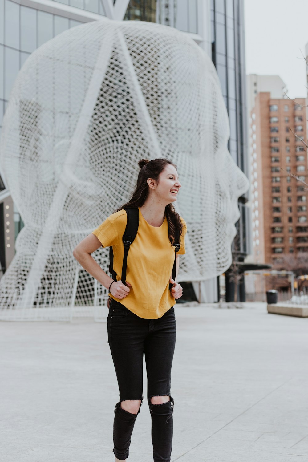 woman wearing yellow t-shirt laughing