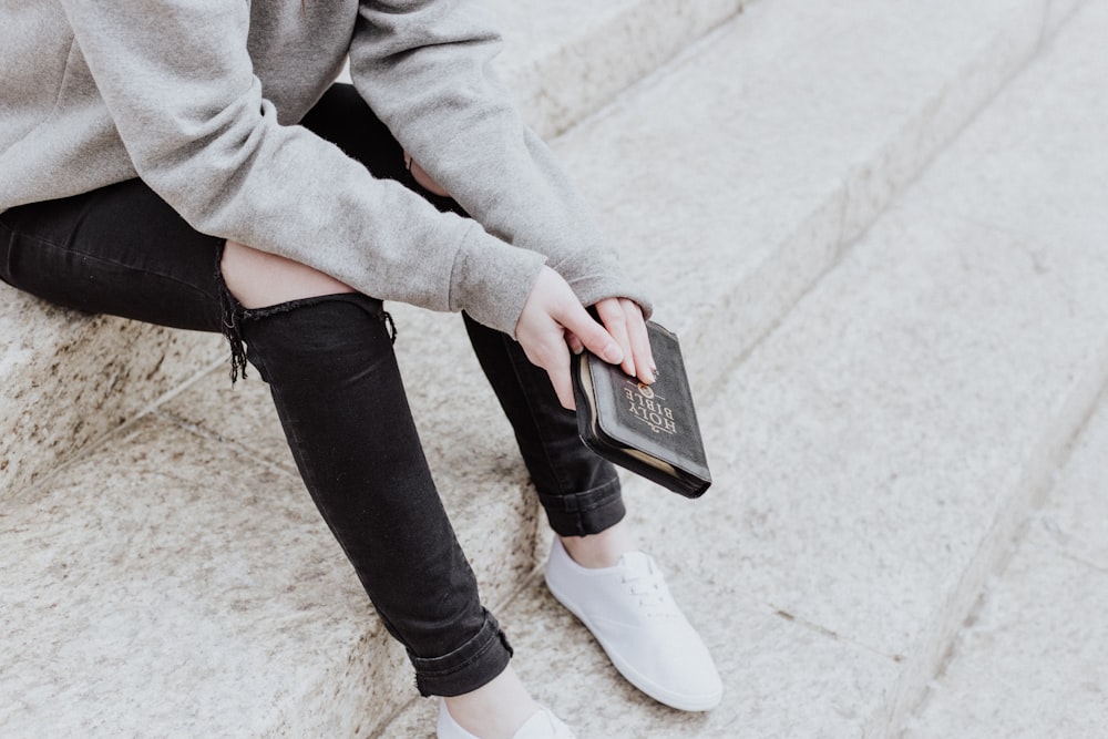 person sitting holding book