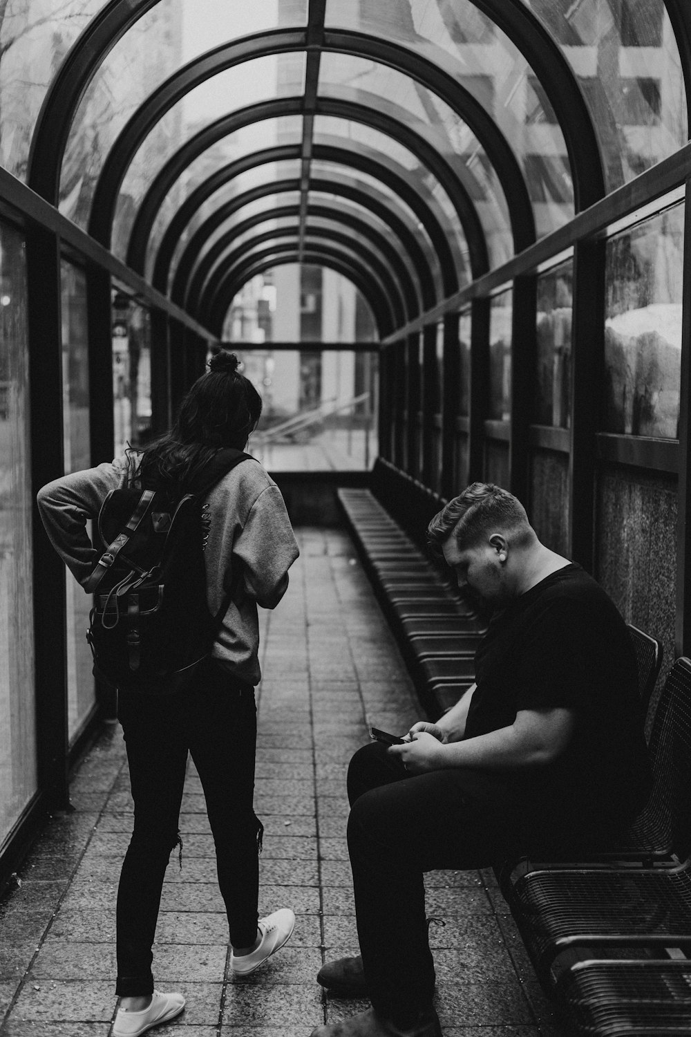 grayscale photo of man and woman inside room