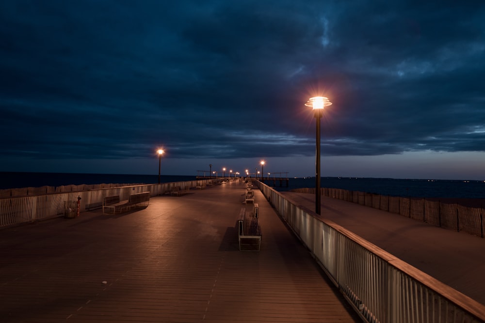 benches near rail and post lamp