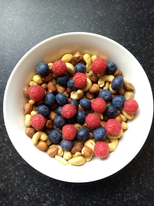 A vibrant bowl of fresh fruits and nuts, symbolizing healthy eating