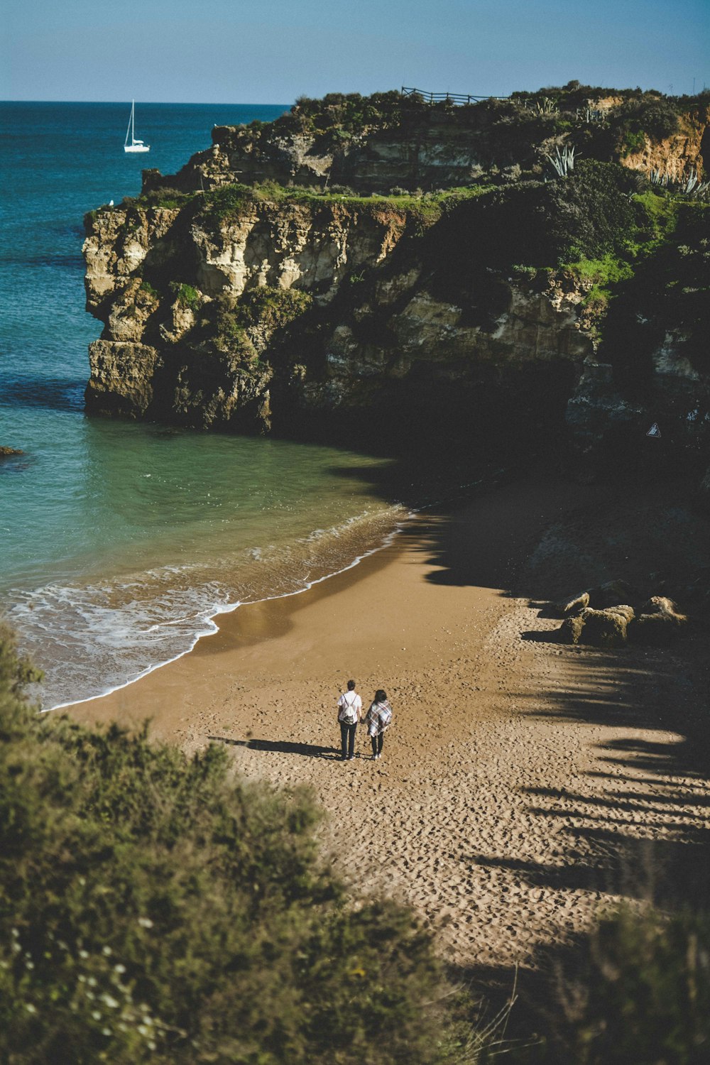 two person standing near seashore