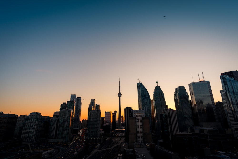 silhouette of high-rise buildings under yellow and blue skies