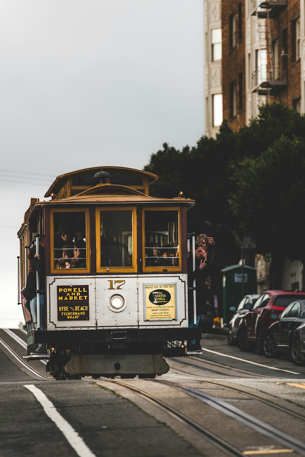 people riding in yellow and gray pram train during daytime