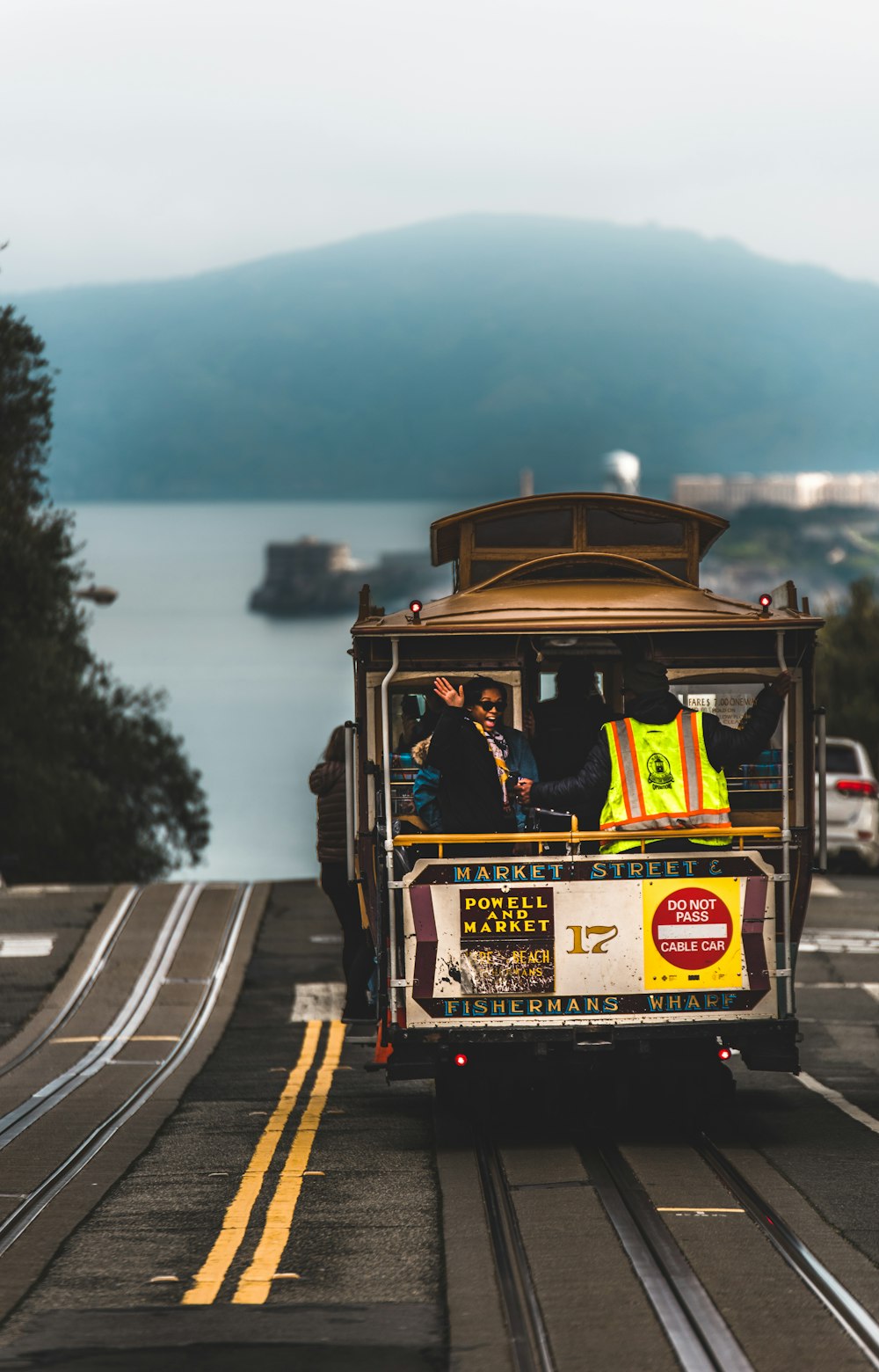 woman waving riding on tram