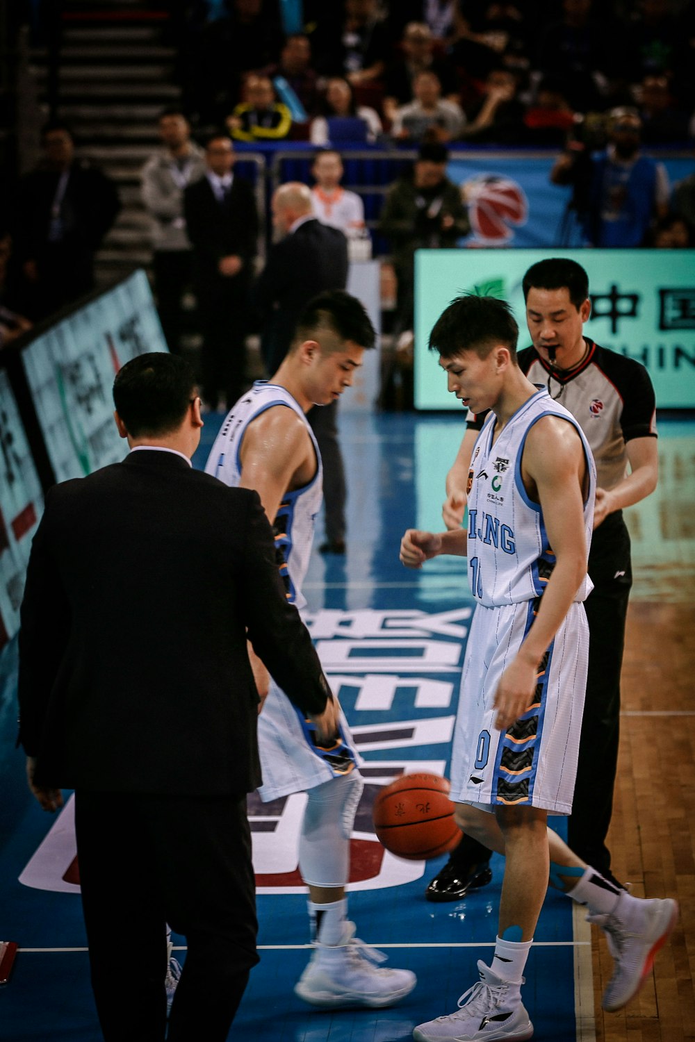 two basketball players facing each other on court