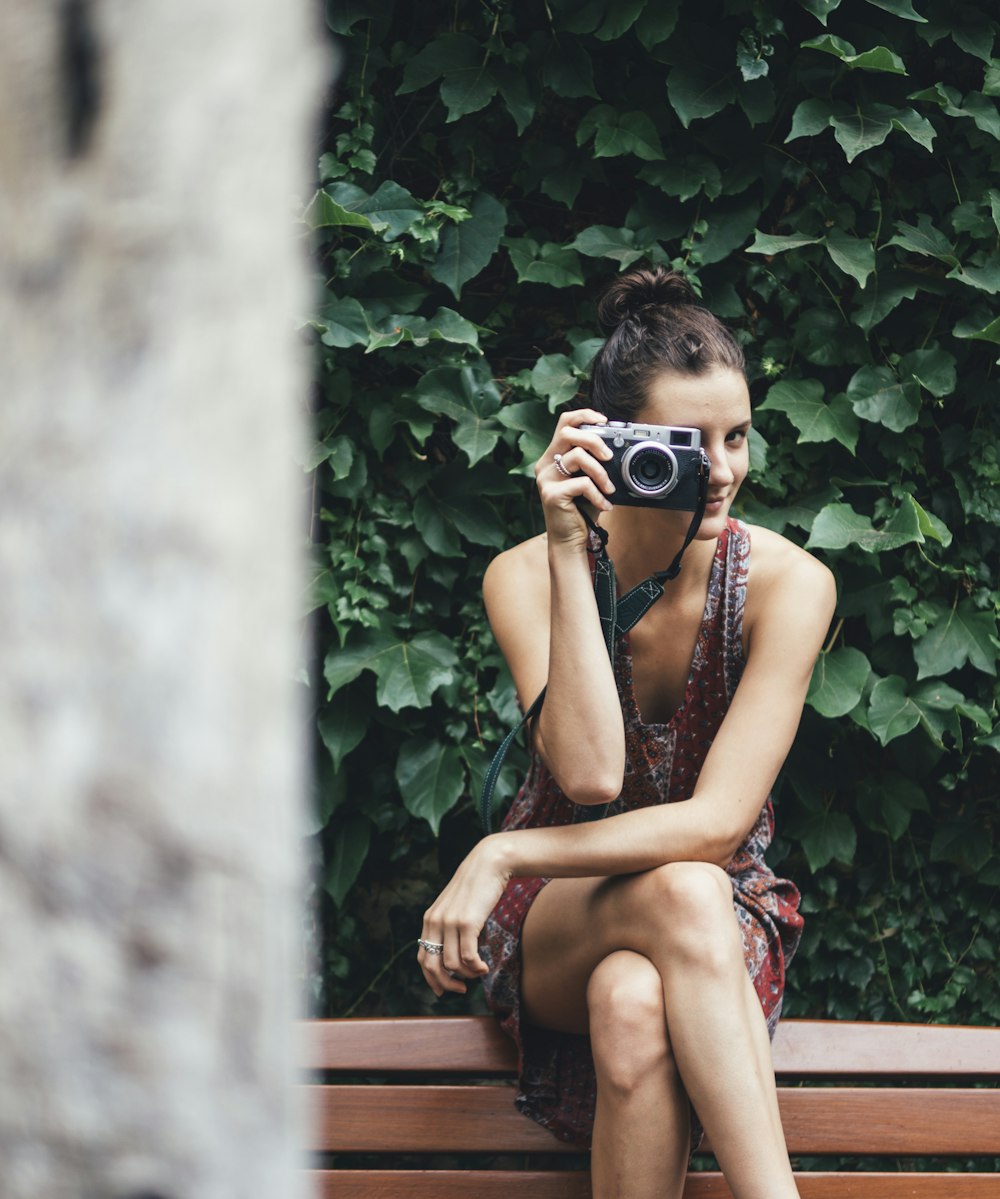 woman holding DSLR camera