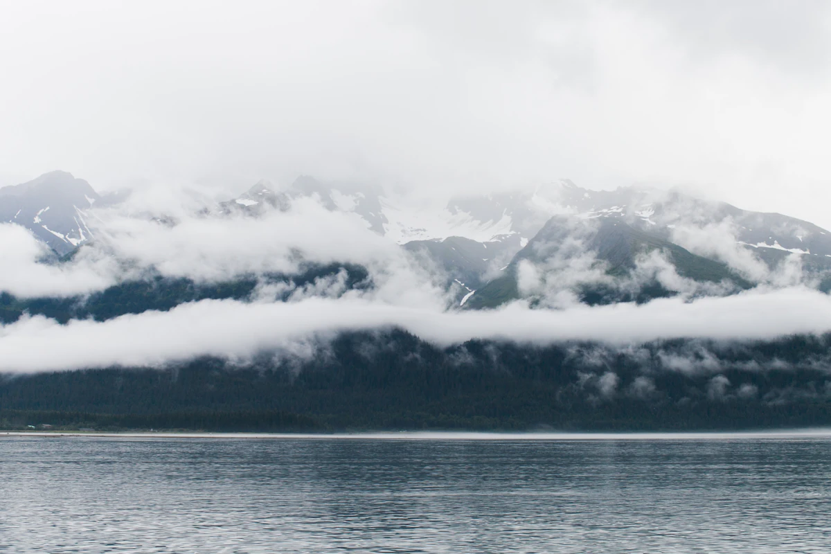 Bands of cloud across the mountains above the water at Seward