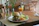 A cozy dining table at Creekstone Hearth with a plate of Swiss mushroom burger and crispy catfish, bathed in warm natural light.