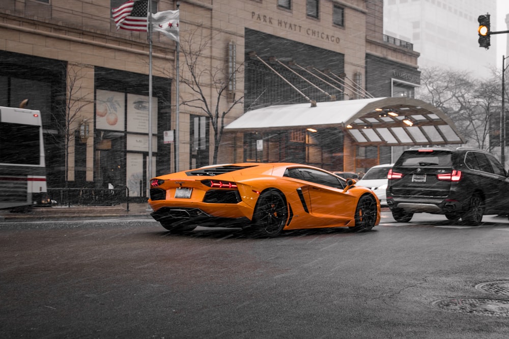 orange coupe on road