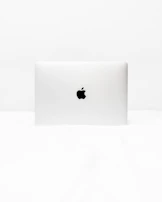 A minimalist black and white logo design displayed on a clean desk.