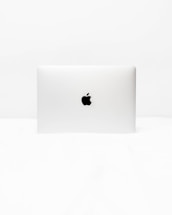 A clean, minimalistic illustration of a laptop with cloud icons floating above it on a white background.