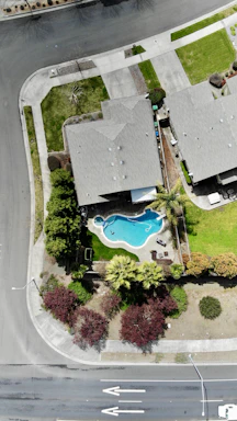 High-angle shot of a newly built suburban home with a pool.
