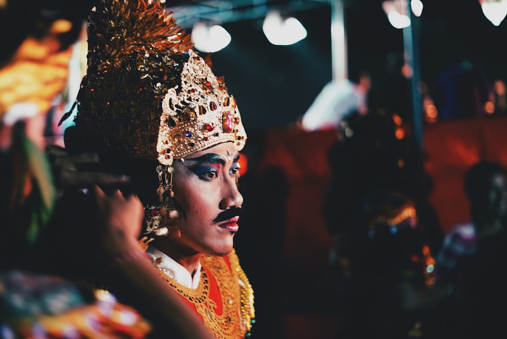 selective photograph of man wearing gold headress