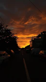 Sunset glow illuminating a quiet suburban neighborhood from the sky.