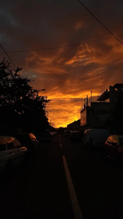 Sunset glow illuminating a quiet suburban neighborhood from the sky.