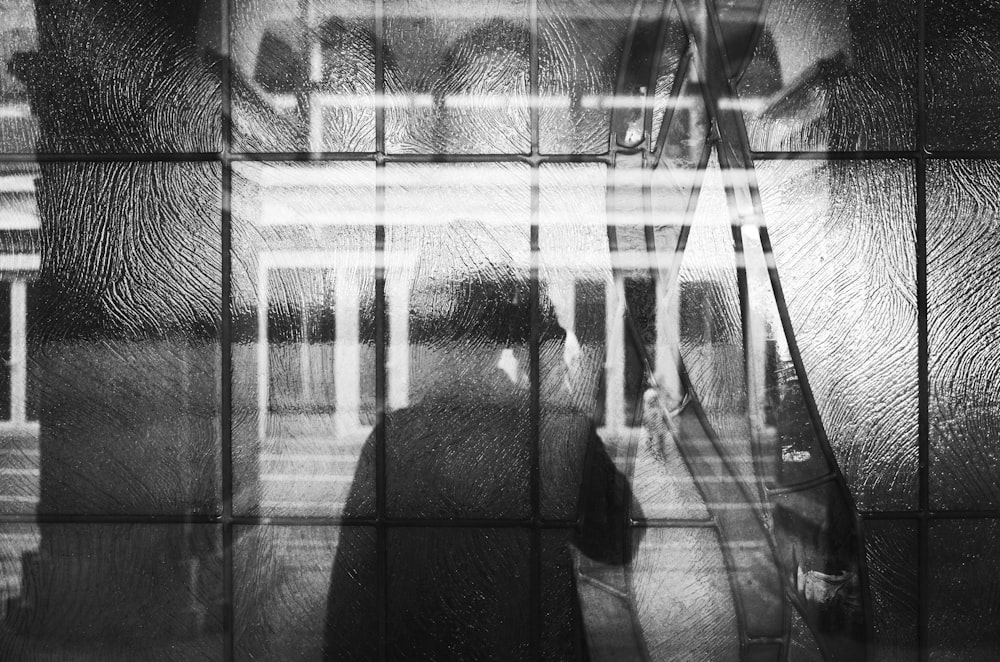 silhoutte of woman on window glass panes