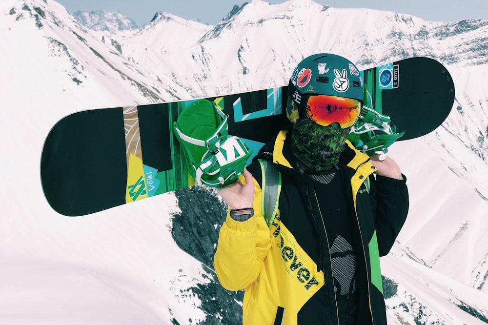 person carrying snowboard with bindings