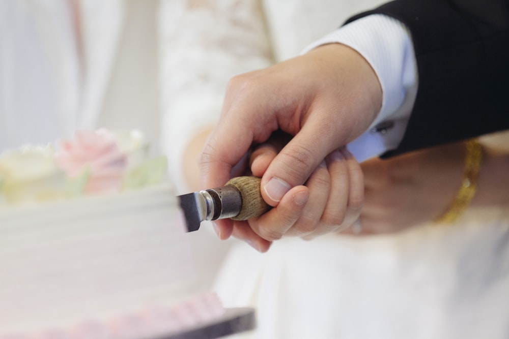 man and woman slicing cake