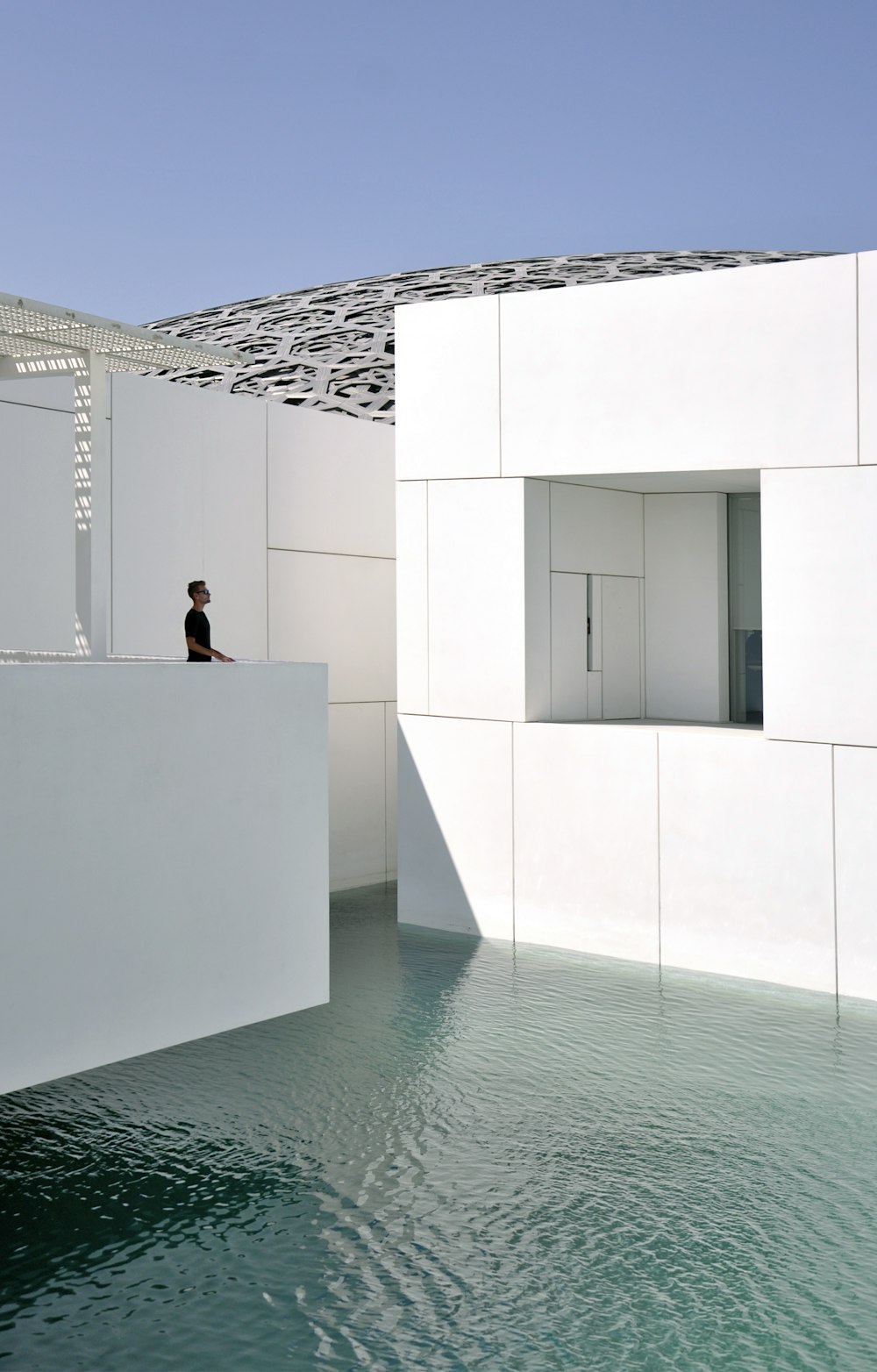 man standing on jacuzzi above body of water