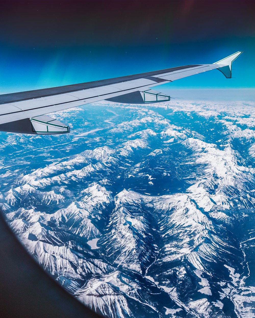 airplane over mountain ridges