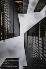 low angle photo of black high rise concrete city buildings