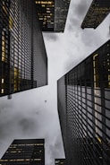 low angle photo of black high rise concrete city buildings