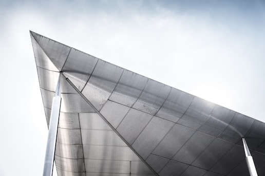 A sleek metal roof gleaming in the afternoon light atop a modern commercial property.