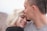 man kissing woman's forehead