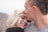man kissing woman's forehead