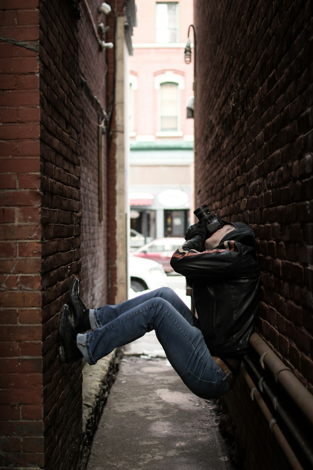 person holding black camera taking a photo while looking up