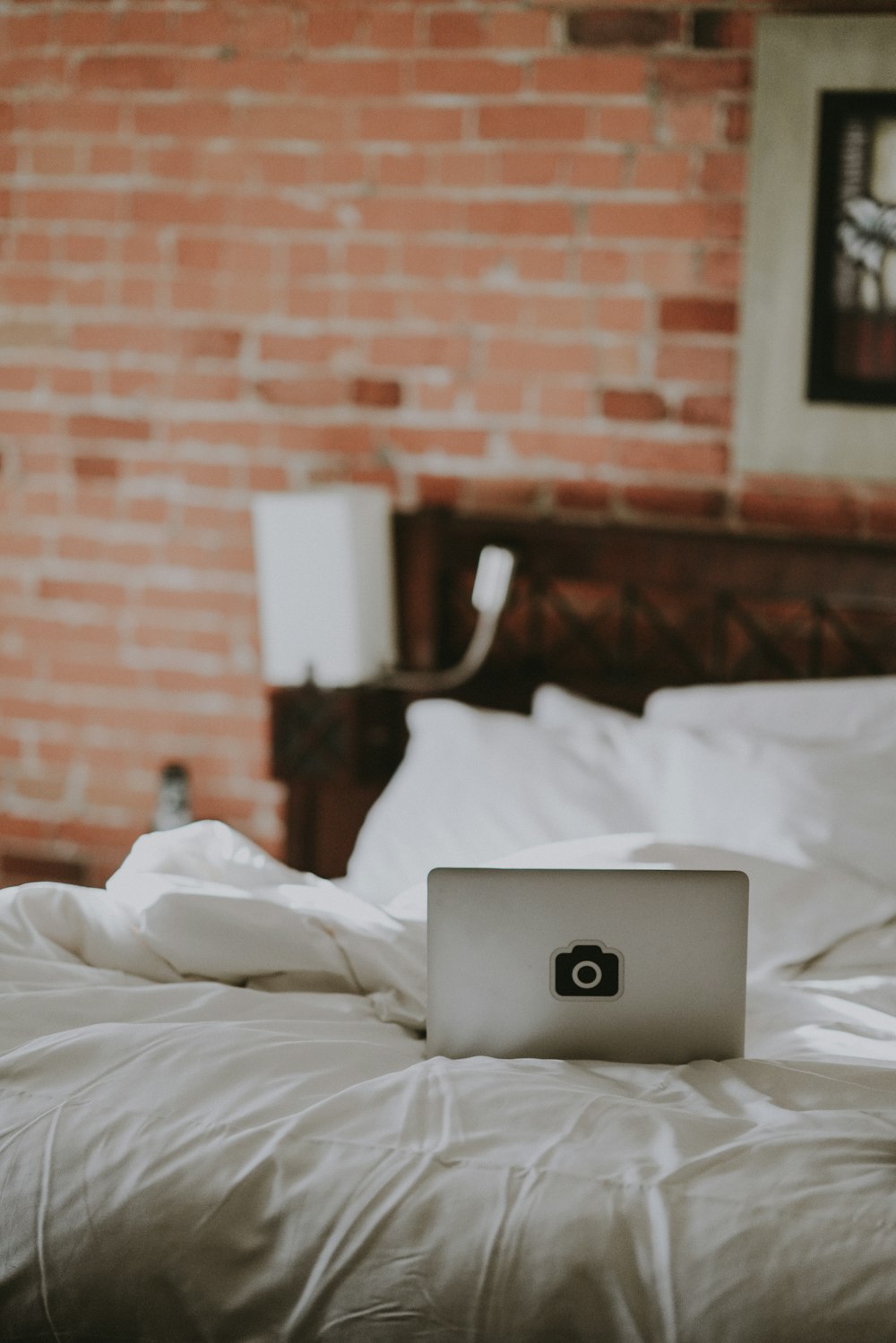 gray laptop computer on white bed comforter