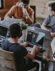 group of people using laptop computer