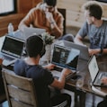 group of people using laptop computer